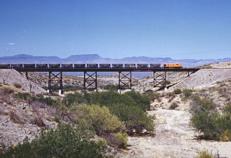 An Alco RS3 diesel-electric locomotive leads a string of hopper cars over a steel trestle on the copper-hauling San Manuel Arizona Railroad in May 1959. Photograph by Fred M. Springer, © 2016, Center for Railroad Photography and Art. Springer-TX1-14-03
