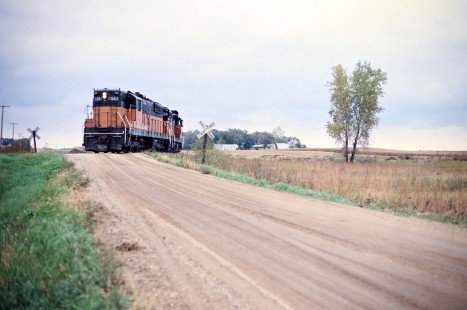 Westbound Milwaukee Road freight train servicing Hollandale at Petran, Minnesota, on September 29, 1977. Photograph by John F. Bjorklund, © 2016, Center for Railroad Photography and Art. Bjorklund-65-20-01
