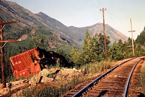 Milwaukee Road wrecked boxcar at Hall Creek, Washington, on July 14, 1979. Photograph by John F. Bjorklund, © 2016, Center for Railroad Photography and Art. Bjorklund-68-11-01