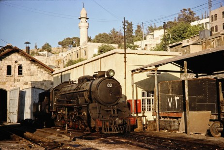 Hedjaz Jordan Railway steam locomotive no. 82 sits in train yard in Amman, Jordan, on July 15, 1991. Photograph by Fred M. Springer, © 2014, Center for Railroad Photography and Art. Springer-Hedjaz-ZimZam(1)-03-12