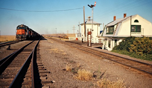 Eastbound Milwaukee Road freight train along eastbound Union Pacific Railroad freight train at Marengo, Washington, on July 25, 1974. The multi-story depot served both railroads. Photograph by John F. Bjorklund, © 2016, Center for Railroad Photography and Art. Bjorklund-64-29-07