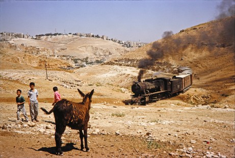 Hedjaz Jordan Railway 2-8-2 steam locomotive no. 71 and several onlookers including a donkey in Amman, Jordan, on July 15, 1991. Photograph by Fred M. Springer, © 2014, Center for Railroad Photography and Art. Springer-Hedjaz-ZimZam(1)-02-10