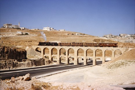 Hedjaz Jordan Railway 2-8-2 steam locomotive no. 51 carrying 4 passenger cars in Amman, Jordan, on July 17, 1991. Photograph by Fred M. Springer, © 2014, Center for Railroad Photography and Art. Springer-Hedjaz-ZimZam(1)-05-17