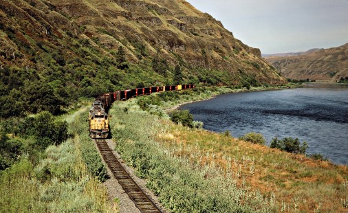 Eastbound Camas Prairie Railroad freight train, owned and operated by Burlington Northern Railroad and Union Pacific Railroad, along Clearwater River near Spalding, Idaho, on July 1, 1988. Photograph by John F. Bjorklund, © 2016, Center for Railroad Photography and Art. Bjorklund-93-17-11