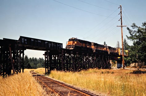 Southbound Milwaukee Road freight train passing over Burlington Northern Railroad track in Rainier, Washington, on July 16, 1979. Photograph by John F. Bjorklund, © 2016, Center for Railroad Photography and Art. Bjorklund-68-15-14