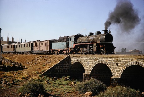 Syrian Railways 2-8-2 steam locomotive no. 263 crossing over a small bridge in Daraa, Daraa, Syria on July 21, 1991. Photograph by Fred M. Springer, © 2014, Center for Railroad Photography and Art. Springer-Hedjaz-ZimZam(1)-11-11