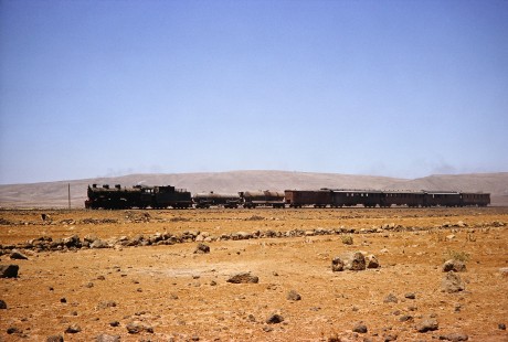 Syrian Railways 2-8-2 steam locomotive no. 263 pulling 7 cars in Daraa, Daraa, Syria on July 21, 1991. Photograph by Fred M. Springer, © 2014, Center for Railroad Photography and Art. Springer-Hedjaz-ZimZam(1)-11-35
