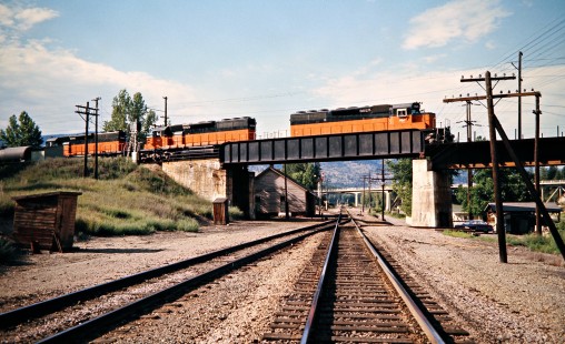 Eastbound Milwaukee Road freight train crossing the Burlington Northern's former Northern Pacific main line in St. Regis, Montana, on July 10, 1973. Photograph by John F. Bjorklund, © 2016, Center for Railroad Photography and Art. Bjorklund-63-21-17