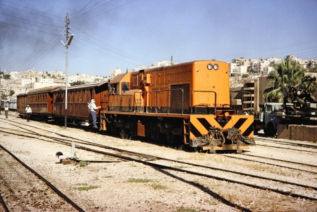 Hedjaz Jordan Railway workers use a diesel locomotive to move passenger cars in Amman, Jordan, on July 15, 1991. Photograph by Fred M. Springer, © 2014, Center for Railroad Photography and Art. Springer-Hedjaz-ZimZam(1)-03-39