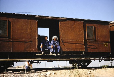 Syrian Railways freight car with two resting rail workers in Damascus, Syria on July 20, 1991. Photograph by Fred M. Springer, © 2014, Center for Railroad Photography and Art. Springer-Hedjaz-ZimZam(1)-09-23