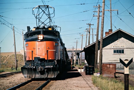 Westbound Milwaukee Road freight train led by a "Little Joe" electric locomotive at Ringling, Montana, on July 7, 1973. Photograph by John F. Bjorklund, © 2016, Center for Railroad Photography and Art. Bjorklund-64-29-12