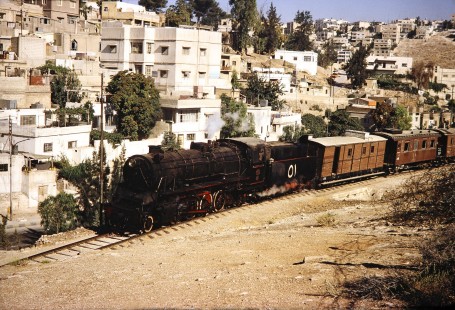 Hedjaz Jordan Railway 2-8-2 steam locomotive no. 51 on a small curve in the track in Amman, Jordan, on July 17, 1991. Photograph by Fred M. Springer, © 2014, Center for Railroad Photography and Art. Springer-Hedjaz-ZimZam(1)-05-25