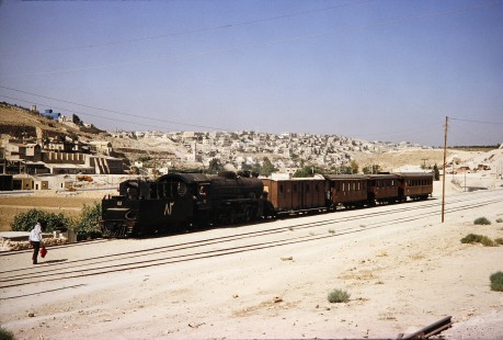 Hedjaz Jordan Railway 4-6-2 steam locomotive no. 82 waits as the engineer speaks with a worker in Amman, Jordan, on July 16, 1991. Photograph by Fred M. Springer, © 2014, Center for Railroad Photography and Art.  Springer-Hedjaz-ZimZam(1)-04-36