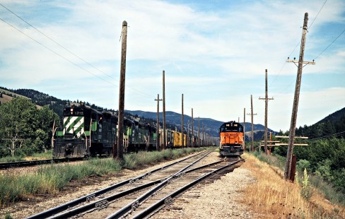 Westbound Milwaukee Road freight train along westbound Burlington Northern Railroad freight train in Iris, Montana, on July 10, 1979. Photograph by John F. Bjorklund, © 2016, Center for Railroad Photography and Art. Bjorklund-64-30-09