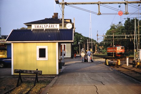 Swedish State Railways electric locomotive passes by Smalsparet station and some tourists in Växjö, Kronoberg , Sweden, on June 2, 1989. Photograph by Fred M. Springer, © 2014, Center for Railroad Photography and Art. Springer-Scan-Swiss-York-03-01