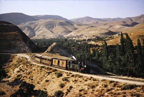 Syrian Railways steam locomotive no. 130-751 pulls three passenger cars in Al-Zabadani, Syria on July 21, 1991. Photograph by Fred M. Springer, © 2014, Center for Railroad Photography and Art. Springer-Hedjaz-ZimZam(1)-10-19