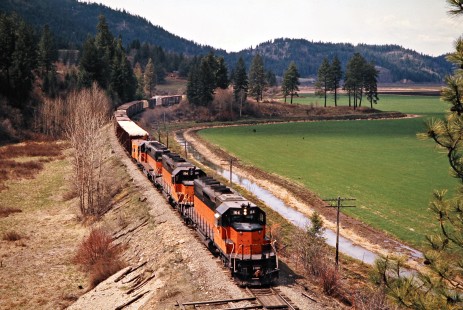 Eastbound Milwaukee Road freight train in St. Maries, Idaho, on April 30, 1975. Photograph by John F. Bjorklund, © 2016, Center for Railroad Photography and Art. Bjorklund-64-22-04