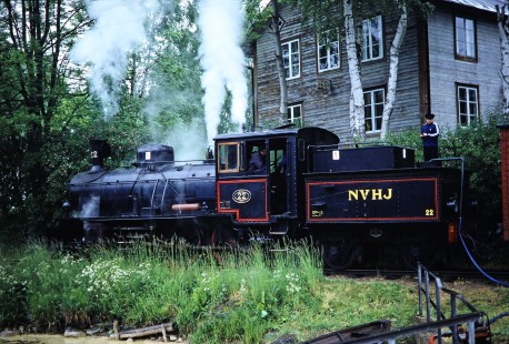 Norsholm–Västervik–Hultsfreds Järnvägar steam locomotive no. 22 waits next to Kalmar station as two workers tend to the train's needs in Kalmar, Sweden, on June 3, 1989. Photograph by Fred M. Springer, © 2014, Center for Railroad Photography and Art. Springer-Scan-Swiss-York-04-16