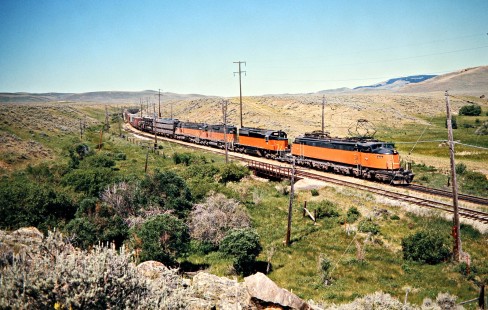 Eastbound Milwaukee Road freight train led by "Little Joe" electric locomotive no. E72 in Loweth, Montana, on July 7, 1973. Photograph by John F. Bjorklund, © 2016, Center for Railroad Photography and Art. Bjorklund-63-14-15