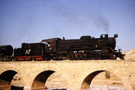 Hedjaz Jordan Railway steam locomotive no. 82 close-up on a small bridge in Amman, Jordan, on July 17, 1991. Photograph by Fred M. Springer, © 2014, Center for Railroad Photography and Art. Springer-Hedjaz-ZimZam(1)-05-34