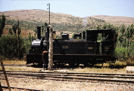 Syrian Railways steam locomotive no. 130-751 gets water in Al-Zabadani, Syria on July 21, 1991. Photograph by Fred M. Springer, © 2014, Center for Railroad Photography and Art.  Springer-Hedjaz-ZimZam(1)-10-30