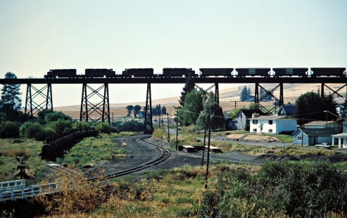 Westbound Milwaukee Road freight train crossing a Union Pacific branch line in Tekoa, Washington, on August 9, 1978. Photograph by John F. Bjorklund, © 2016, Center for Railroad Photography and Art. Bjorklund-67-09-01