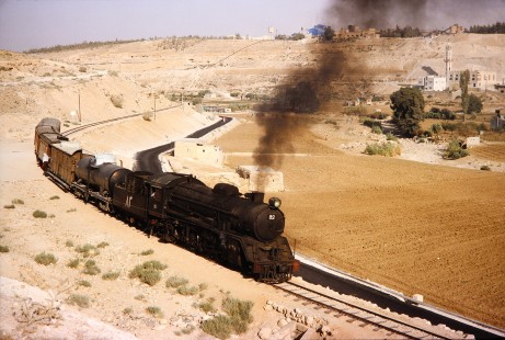 Hedjaz Jordan Railway steam locomotive no. 82 moves along a small curve in Amman, Jordan, on July 17, 1991. Photograph by Fred M. Springer, © 2014, Center for Railroad Photography and Art. Springer-Hedjaz-ZimZam(1)-05-37