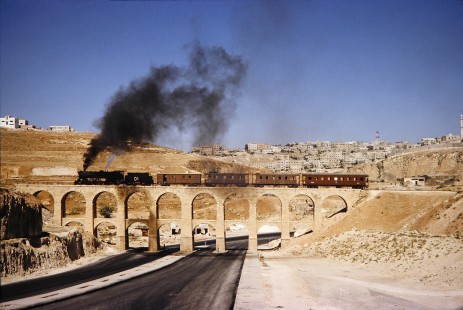 Hedjaz Jordan Railway 2-8-2 steam locomotive no. 51 on a bridge passing over a highway in Amman, Jordan, on July 17, 1991. Photograph by Fred M. Springer, © 2014, Center for Railroad Photography and Art. Springer-Hedjaz-ZimZam(1)-05-15