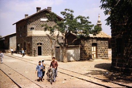 Syrian Railways Station with many surrounding people in Daraa, Daraa, Syria on July 19, 1991. Photograph by Fred M. Springer, © 2014, Center for Railroad Photography and Art. Springer-Hedjaz-ZimZam(1)-08-29