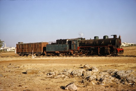 Syrian Railways 2-8-2 steam locomotive no. 263 pulling a single car in Daraa, Daraa, Syria on July 21, 1991. Photograph by Fred M. Springer, © 2014, Center for Railroad Photography and Art. Springer-Hedjaz-ZimZam(1)-11-06