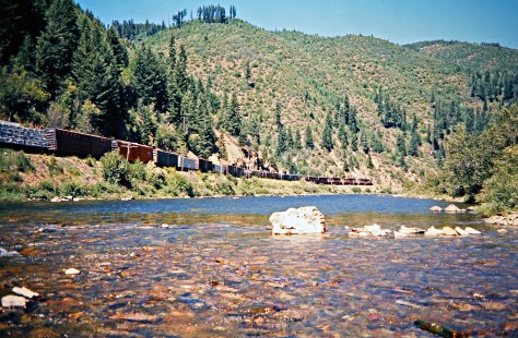 Eastbound Milwaukee Road freight train along the St. Joe River in Avery, Idaho, on July 11, 1973. Photograph by John F. Bjorklund, © 2016, Center for Railroad Photography and Art. Bjorklund-63-24-02
