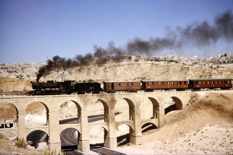 Hedjaz Jordan Railway 2-8-2 steam locomotive no. 71 traveling on the aqueduct bridge in Amman, Jordan, on July 15, 1991. Photograph by Fred M. Springer, © 2014, Center for Railroad Photography and Art.  Springer-Hedjaz-ZimZam(1)-02-21