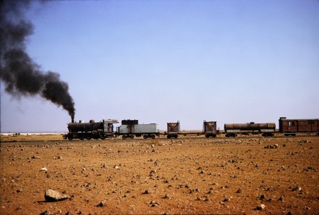 Syrian Railways steam locomotive no. 162 pulling freight cars in Daraa, Daraa, Syria on July 19, 1991. Photograph by Fred M. Springer, © 2014, Center for Railroad Photography and Art. Springer-Hedjaz-ZimZam(1)-08-14