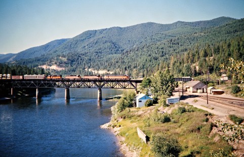 Westbound Milwaukee Road freight train crossing the Clark Fork River at St. Regis, Montana, on July 11, 1973. Photograph by John F. Bjorklund, © 2016, Center for Railroad Photography and Art. Bjorklund-63-23-20