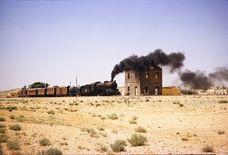 Hedjaz Jordan Railway 4-6-2 steam locomotive no. 82 pulls in to a small station near Amman, Jordan, on July 16, 1991. Photograph by Fred M. Springer, © 2014, Center for Railroad Photography and Art.  Springer-Hedjaz-ZimZam(1)-04-21