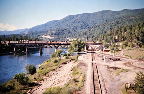 Westbound Milwaukee Road freight train crossing the Clark Fork River and the Burlington Northern's former Northern Pacific main lineat St. Regis, Montana, on July 11, 1973. Photograph by John F. Bjorklund, © 2016, Center for Railroad Photography and Art. Bjorklund-63-23-19