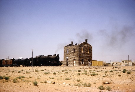Hedjaz Jordan Railway 4-6-2 steam locomotive no. 82 waits next to an un-roofed station near Amman, Jordan, on July 16, 1991. Photograph by Fred M. Springer, © 2014, Center for Railroad Photography and Art. Springer-Hedjaz-ZimZam(1)-04-23