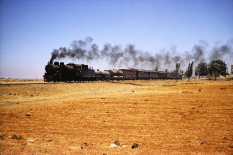 Syrian Railways 2-8-2 steam locomotive no. 263 pulling 7 cars in Daraa, Daraa, Syria on July 21, 1991. Photograph by Fred M. Springer, © 2014, Center for Railroad Photography and Art. Springer-Hedjaz-ZimZam(1)-11-38