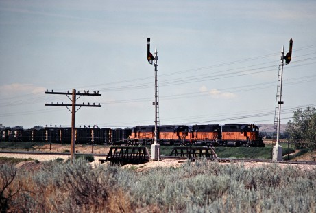Eastbound Milwaukee Road coal train, with Burlington Northern Railroad track in foreground, at Miles City, Montana, on July 18, 1980. Photograph by John F. Bjorklund, © 2016, Center for Railroad Photography and Art. Bjorklund-68-22-06