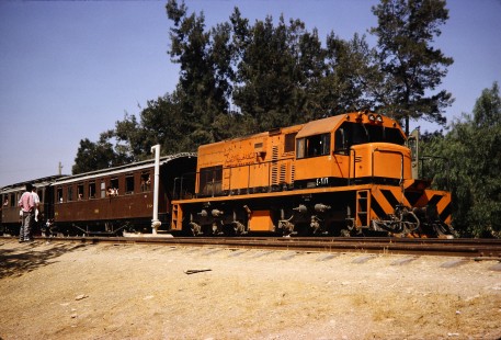 Syrian Railways diesel locomotive no. 4-212 pulls passenger cars as workers watch on trackside in Daraa, Daraa, Syria on July 19, 1991. Photograph by Fred M. Springer, © 2014, Center for Railroad Photography and Art. Springer-Hedjaz-ZimZam(1)-07-13