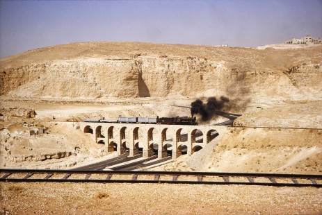 Hedjaz Jordan Railway 2-8-2 steam locomotive no. 71 travels on the aqueduct bridge in Amman, Jordan, on July 15, 1991. Photograph by Fred M. Springer, © 2014, Center for Railroad Photography and Art. Springer-Hedjaz-ZimZam(1)-03-32