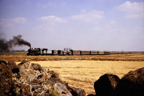 Syrian Railways steam locomotive no. 162 traveling through open fields in Daraa, Daraa, Syria on July 19, 1991. Photograph by Fred M. Springer, © 2014, Center for Railroad Photography and Art. Springer-Hedjaz-ZimZam(1)-08-26