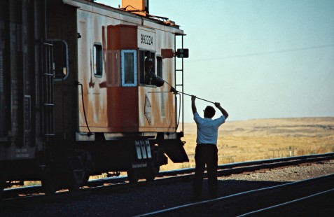 Milwaukee Road crewman passing orders to eastbound freight train in Marengo, Washington, on July 25, 1974. Photograph by John F. Bjorklund, © 2016, Center for Railroad Photography and Art. Bjorklund-64-16-17