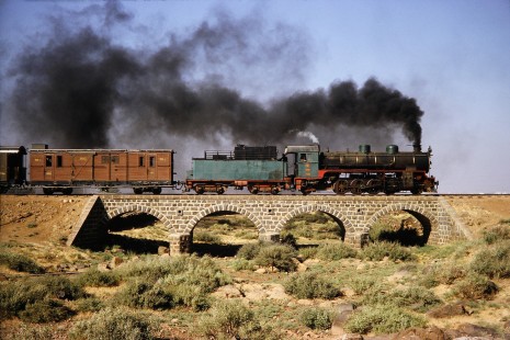 Syrian Railways 2-8-2 steam locomotive no. 263 crossing over a small bridge in Daraa, Daraa, Syria on July 21, 1991. Photograph by Fred M. Springer, © 2014, Center for Railroad Photography and Art. Springer-Hedjaz-ZimZam(1)-11-12