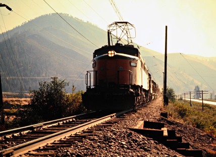 Westbound Milwaukee Road freight train led by a "Little Joe" electric locomotive in Superior, Montana, on July 18, 1973. Photograph by John F. Bjorklund, © 2016, Center for Railroad Photography and Art. Bjorklund-64-02-15
