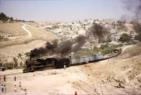 Hedjaz Jordan Railway 2-8-2 steam locomotive no. 71 surrounded by onlookers in Amman, Jordan, on July 15, 1991. Photograph by Fred M. Springer, © 2014, Center for Railroad Photography and Art. Springer-Hedjaz-ZimZam(1)-03-33