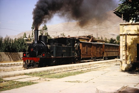 Syrian Railways steam locomotive no. 130-751 pulls into a station in Al-Zabadani, Syria on July 21, 1991. Photograph by Fred M. Springer, © 2014, Center for Railroad Photography and Art.  Springer-Hedjaz-ZimZam(1)-10-29