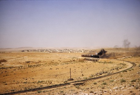 Hedjaz Jordan Railway 4-6-2 steam locomotive no. 82 travels along a curved stretch of track in Amman, Jordan, on July 16, 1991. Photograph by Fred M. Springer, © 2014, Center for Railroad Photography and Art. Springer-Hedjaz-ZimZam(1)-04-17