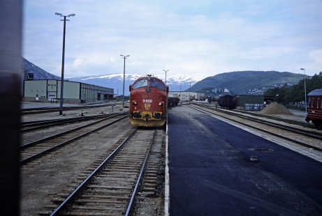 GM-Gruppen diesel locomotive no. 3602 moves forward on the rail seen against the mountainous landscape in Mosjøen, Nordland, Norway on June 7, 1989. This photograph is taken as the photographer travels the areas of Nordland and Sør-Trøndelag, Norway. Photograph by Fred M. Springer, © 2014, Center for Railroad Photography and Art. Springer-Scan-Swiss-York-08-23