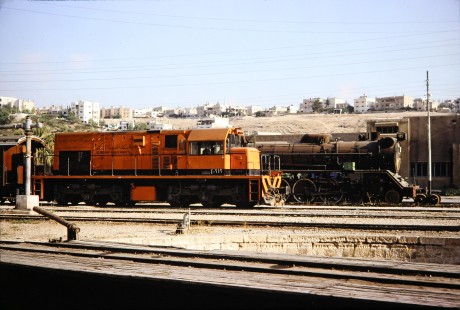 Syrian Railways locomotive no. 162 and diesel locomotive no. 4-212 in Daraa, Daraa, Syria on July 19, 1991. Photograph by Fred M. Springer, © 2014, Center for Railroad Photography and Art. Springer-Hedjaz-ZimZam(1)-07-17